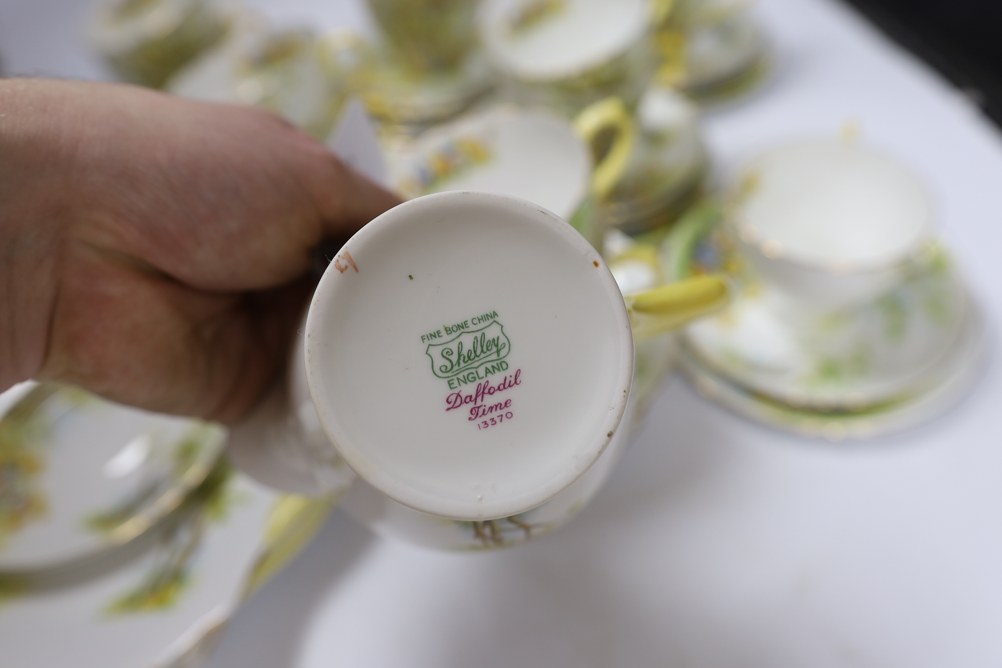 A Shelley ‘Daffodil Time’ pattern tea set with thirteen trios, three sandwich plates, milk jug and bowl, largest 24cm wide